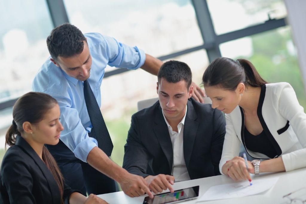 Group of happy young business people in a meeting at office Interactive Meeting Technology